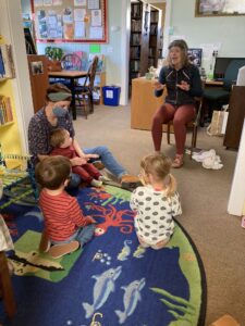 Librarian reading stories to children